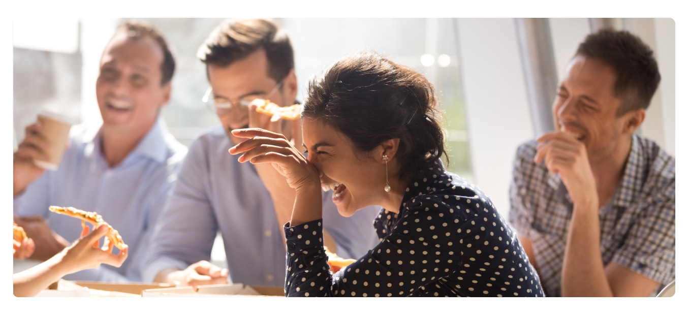 Image of team members eating together to celebrate employee appreciation day.