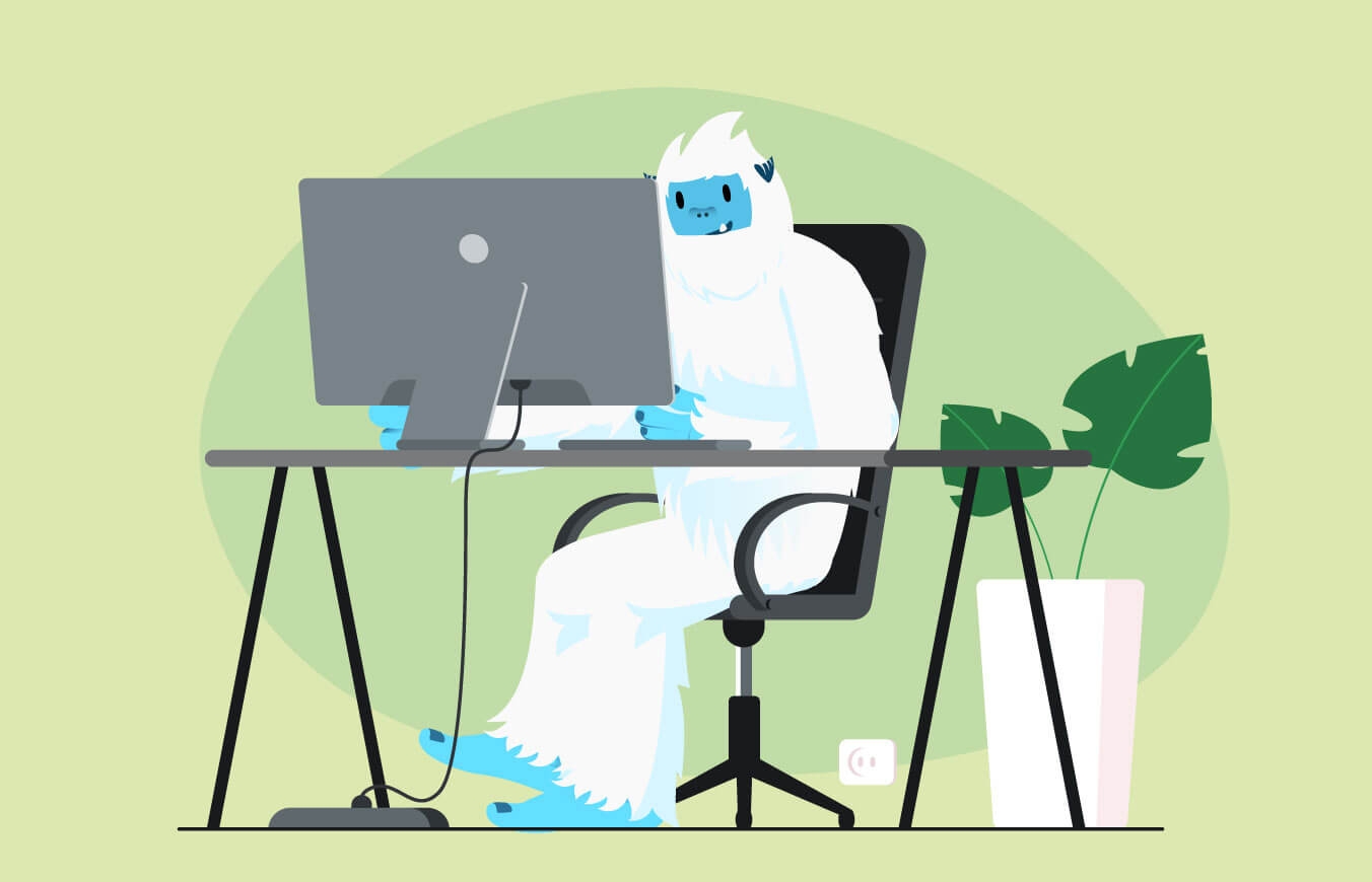 Illustration of Carl the yeti sitting at a desk with a computer, working from home.