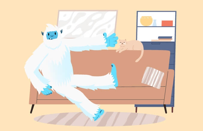 Illustration of Carl the yeti sitting on couch typing next to a cat.